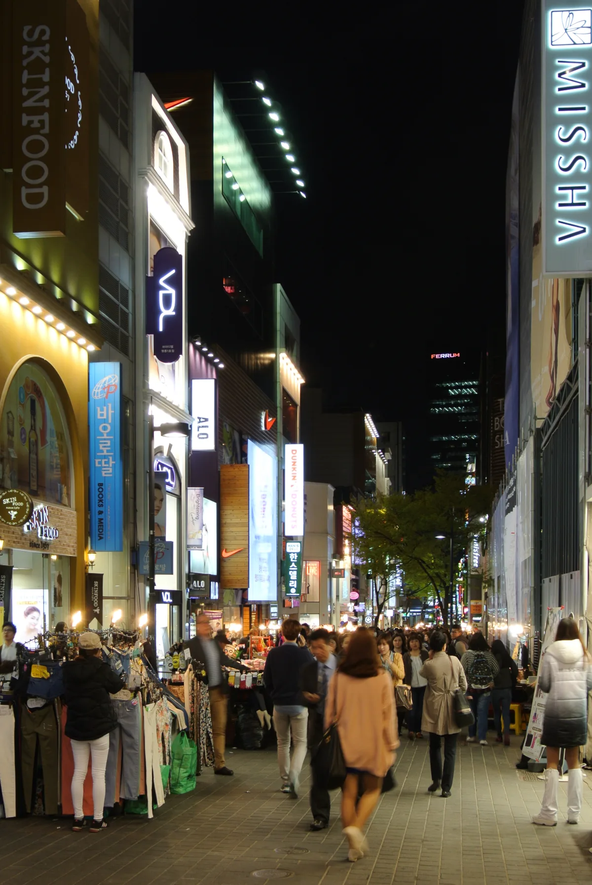 A brightly lit shopping street in Myeongdong, Seoul at night